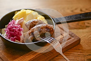 Traditional Ukrainian cuisine. Pork sausages with mashed potatoes and cabagge salad served in a pan. photo