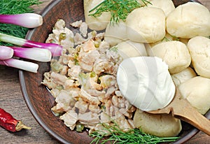 Traditional Ukrainian Poltava dumplings with meat and sour cream. close up. top view