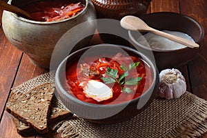 Traditional Ukrainian Russian borscht . Bowl of red beet root soup borsch with white cream