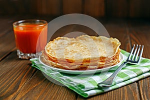 Traditional Ukrainian or Russian pancakes and carrot juice. The