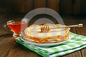 Traditional Ukrainian or Russian pancakes and honey. The concept