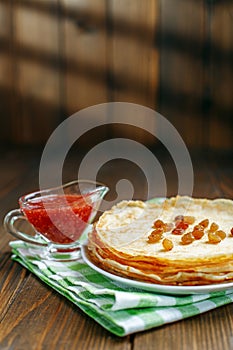 Traditional Ukrainian or Russian pancakes with raisins and jam.