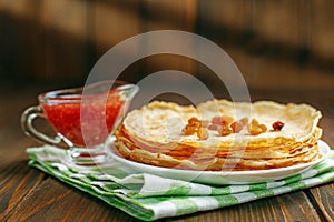 Traditional Ukrainian or Russian pancakes with raisins and jam.The concept of food, breakfast, pancake week.