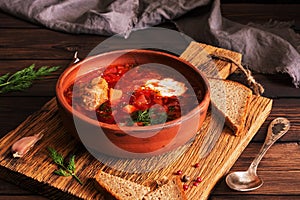 Traditional Ukrainian Russian red soup borscht with meat and sour cream. Selective focus