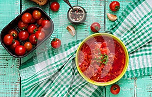 Traditional Ukrainian Russian vegetable borscht soup on green bowl.