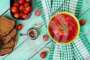 Traditional Ukrainian Russian vegetable borscht soup on green bowl.