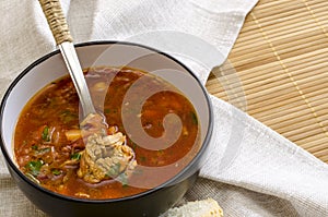 Traditional Ukrainian Russian vegetable soup borscht, with hard cream. parsley rye bread rolls