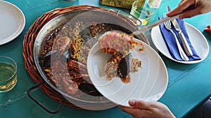 Traditional Valencian paella marinera with shrimps and mussels served on iron frypan