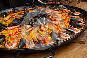 Traditional Valencian seafood paella with prawns and mussels photo