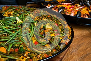 Traditional Valencian vegetarian vegetable paella with snap-beans photo