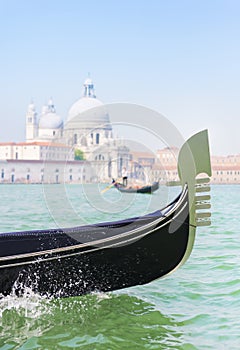 Traditional venetian gondola and gondolier with tourists between
