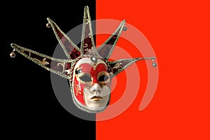 Traditional Venetian mask on a black and red background