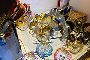 Traditional venician masks on shelves in souvenirs shop in Venice