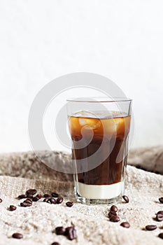 Traditional vietnamese iced coffee with condensed milk and coffee beans