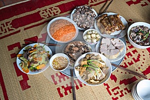 A traditional Vietnamese meal for lunar new year Tet holiday in spring, placed on new flowered sedge mat, on the last day of the l