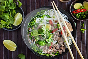 Traditional Vietnamese soup Pho with beef and rice noodle photo