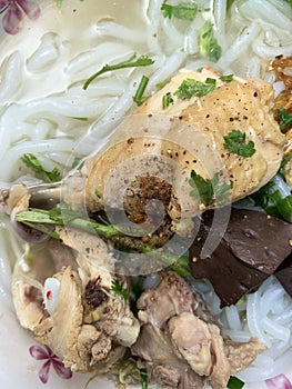 A traditional Vietnamese street food name is Banh Canh, noodle soup of recipe: chicken drumstick, pepper and onion