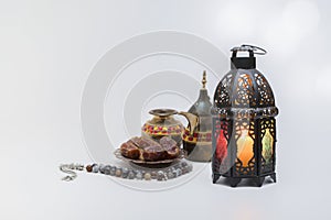 Traditional view of Lantern with coffee pot, date fruits and rosary beads.