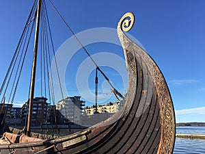 A traditional viking ship docked in Oslo harbor fjord