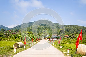 A traditional village entrance with flags , in Asia, Vietnam, Tonkin, between Dien Bien Phu and Lai Chau, in summer on a sunny day