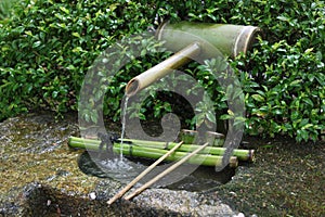 Traditional water spring with bamboo ladles in Japan