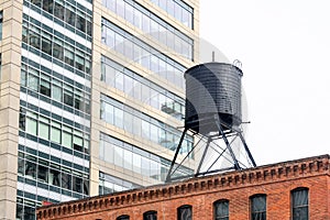 Traditional water tank on the roof of an old brick building