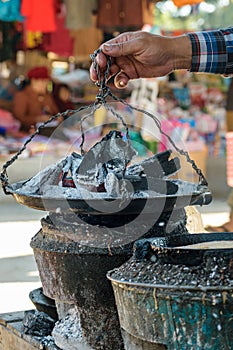 Traditional way of cooking over charcoal, Myanmar