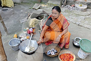 Traditional way of making food on open fire in old kitchen in a village, Kumrokhali, India