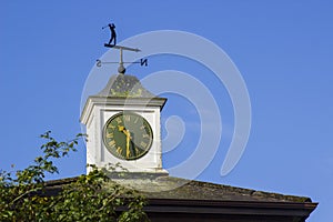 A traditional weather vane in a golfer`s theme on top of a golf pro shop and Brasserie at the a golf resort Northern Ireland