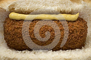 Traditional white bun with a Dutch kroket and mustard