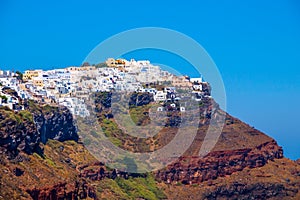 Traditional white cave houses on a cliff on the island Santorini