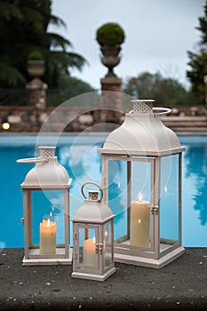 Traditional white lanterns in a garden with pool