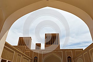 Traditional wind towers of Yazd View from under an arch, Yazd has a unique Iranian architecture.