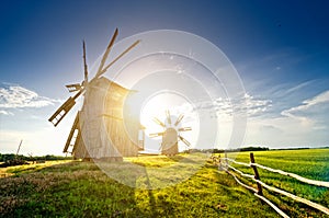 A traditional windmill on the countryside at sunset