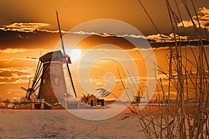 Traditional windmill and ice at dawn, Kinderdijk, Netherlands