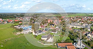 Traditional Windmill with Local Fair on Dutch Island Ameland - Hollum, Ameland, The Netherlands, 4K Drone Footage