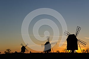 Traditional windmills in a row by sunset