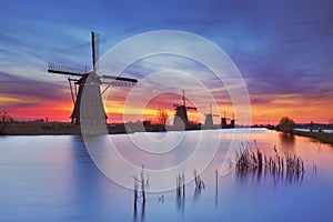 Traditional windmills at sunrise, Kinderdijk, The Netherlands photo