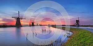 Traditional windmills at sunrise in The Netherlands