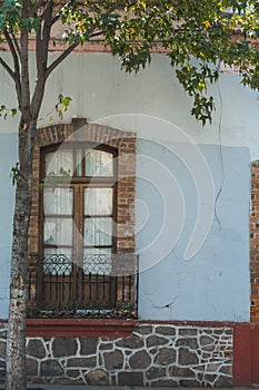 Traditional windows of the Mexican towns, vintage style made from roho partition, blacksmith and stone photo