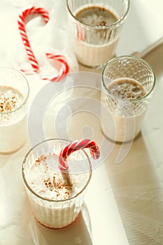 Traditional winter delicious homemade Christmas cocktail eggnog with milk, rum,cinnamon and nutmeg