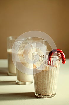 Traditional winter delicious homemade Christmas cocktail eggnog with milk, rum and cinnamon nutmeg