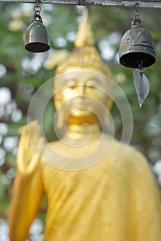 Traditional wish bells and blurred Famous Buddha statue background Thailand