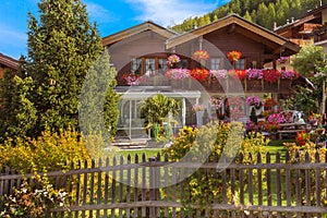 Traditional wooden alpine chalet with flowers