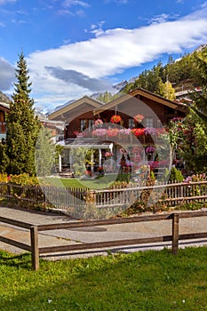 Traditional wooden alpine chalet with flowers