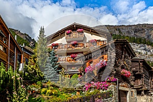 Traditional wooden alpine chalet with flowers