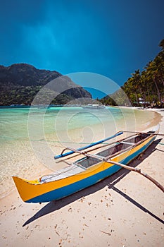 Traditional wooden banca boat on beautiful Corong Corong beach near El Nido village. Summer exotic vacation and Island