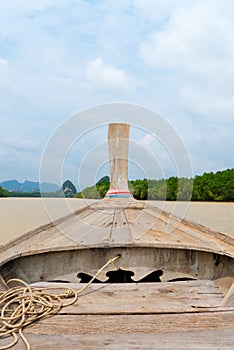 Traditional wooden boat against tropical background