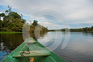 Traditional wooden boat floats on the Amazon river in the jungle. Amazon River Manaus, Amazonas, Brazil