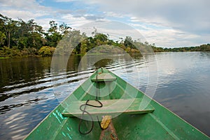 Traditional wooden boat floats on the Amazon river in the jungle. Amazon River Manaus, Amazonas, Brazil